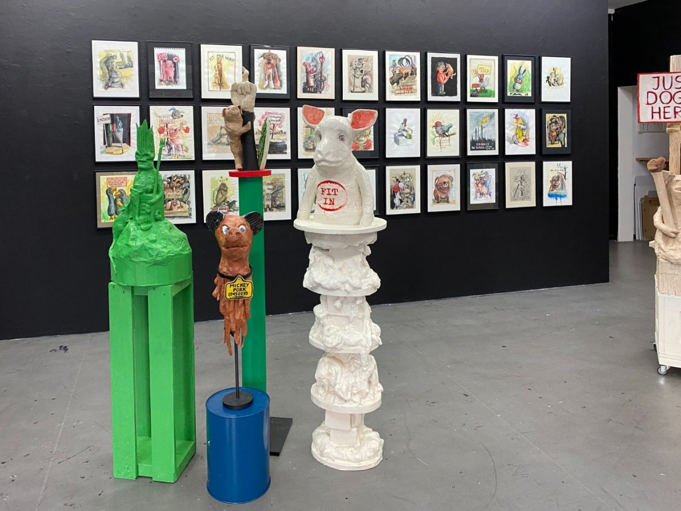 Installation view of The Way Things Seem at Gallery Daeppen, Basel, with sculptural figures positioned in front of a wall of framed drawings.