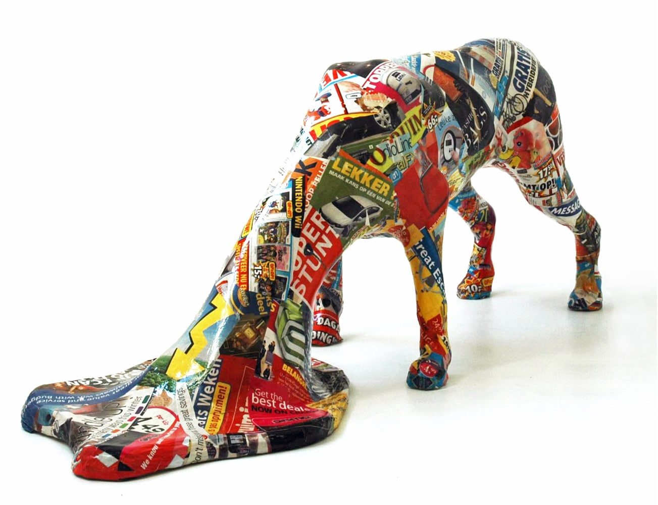 Dog-like sculptural figure with its head extending and spreading across the floor.