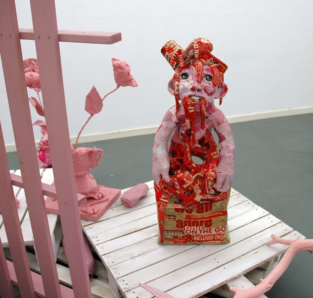 Installation view of Platonic Ideals & Hot Ketchup, with red and white sculptural figures and objects.