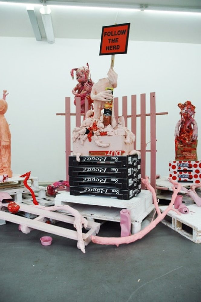 Installation view of Platonic Ideals & Hot Ketchup, with red and white sculptural figures and objects.