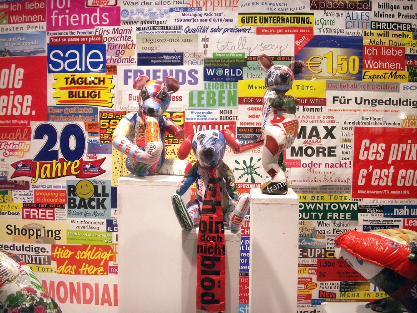 Sculptural installation in a commercial shop window, set against a backdrop made from cut-up plastic shopping bags.