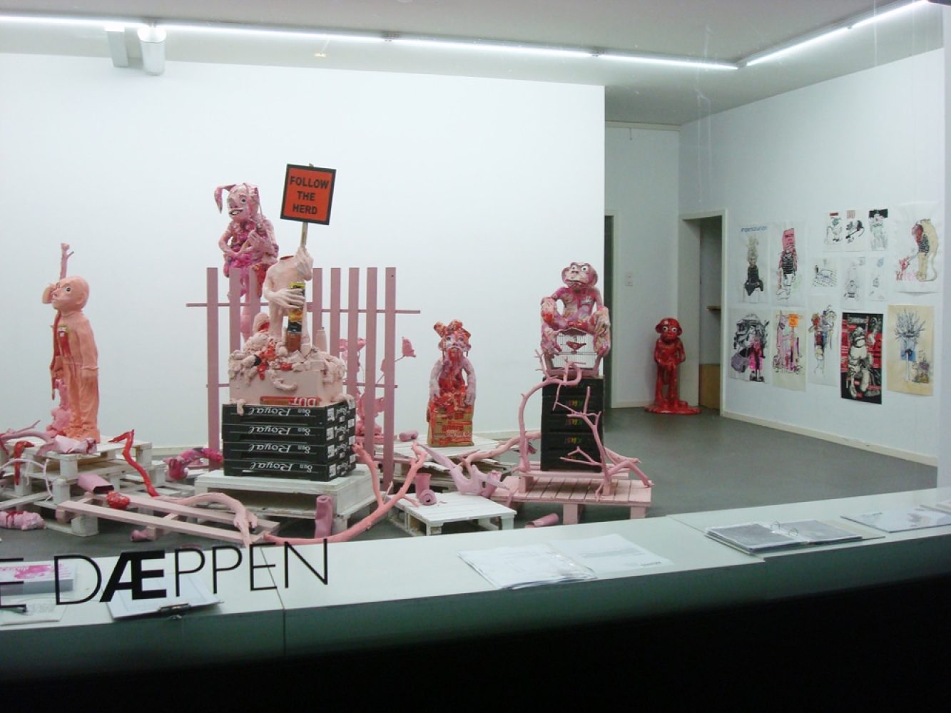 Installation view of Platonic Ideals & Hot Ketchup, with red and white sculptural figures and objects.