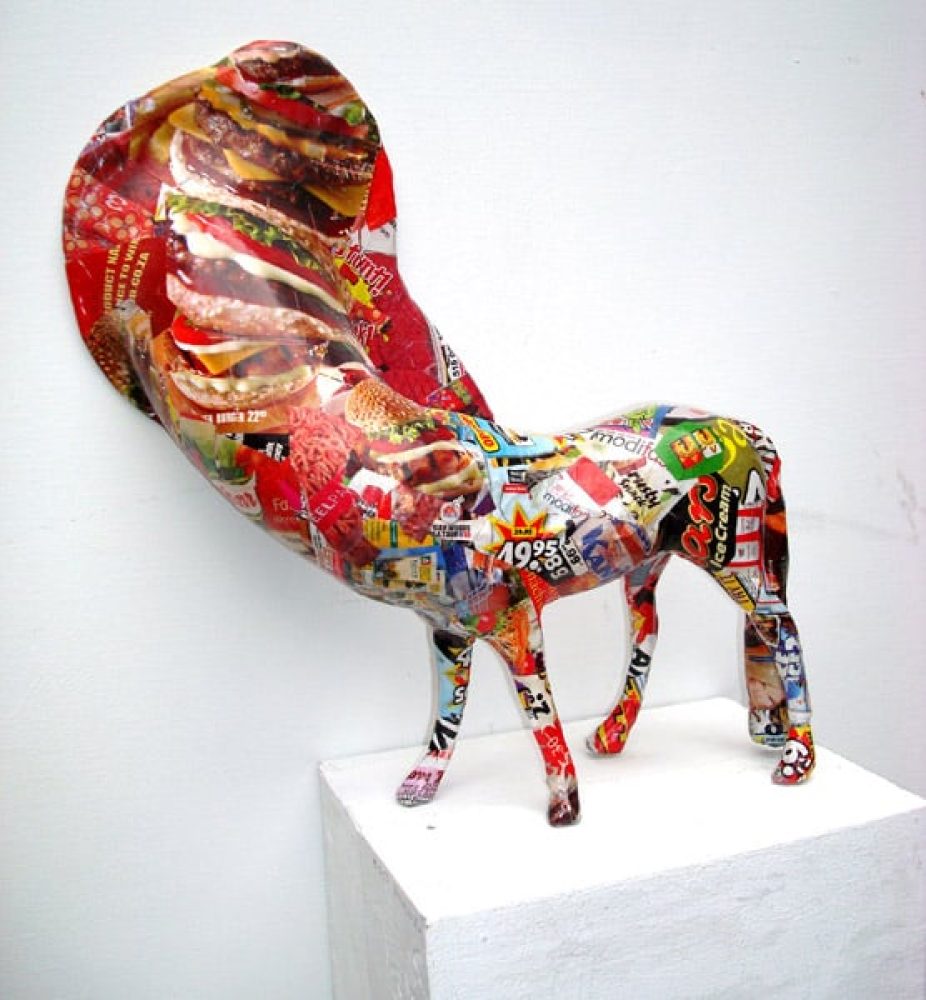Small animal-like sculptural figure mounted on a wooden box.