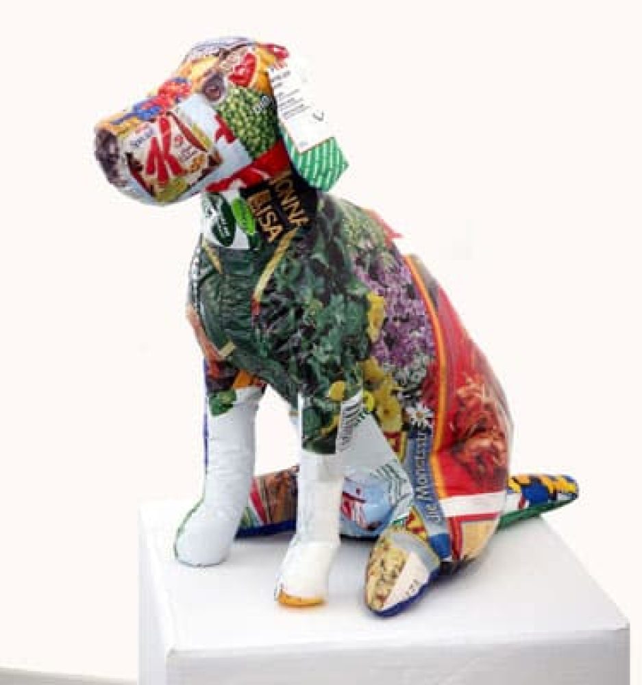 Seated dog sculpture sewn from discarded plastic shopping bags.