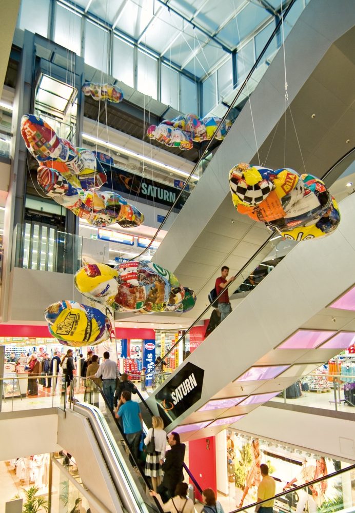 Large cloud forms made from plastic bags suspended high above the interior of Passage shopping centre in Linz.
