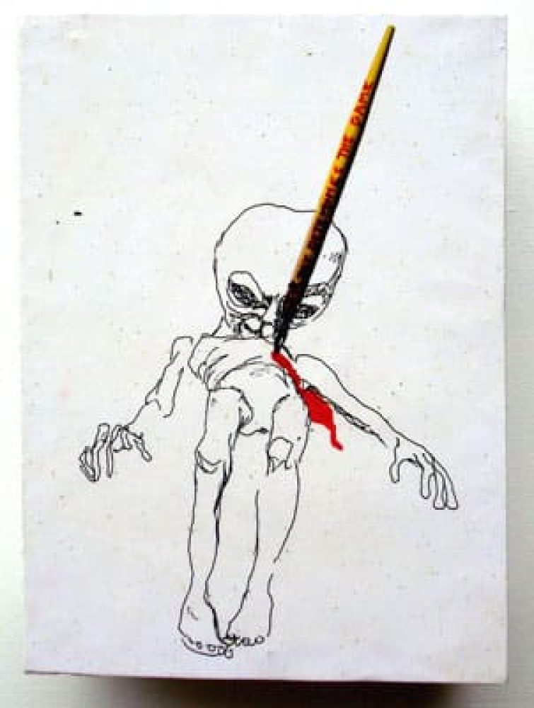Pen drawing of an elongated alien-like figure on a white wooden box.