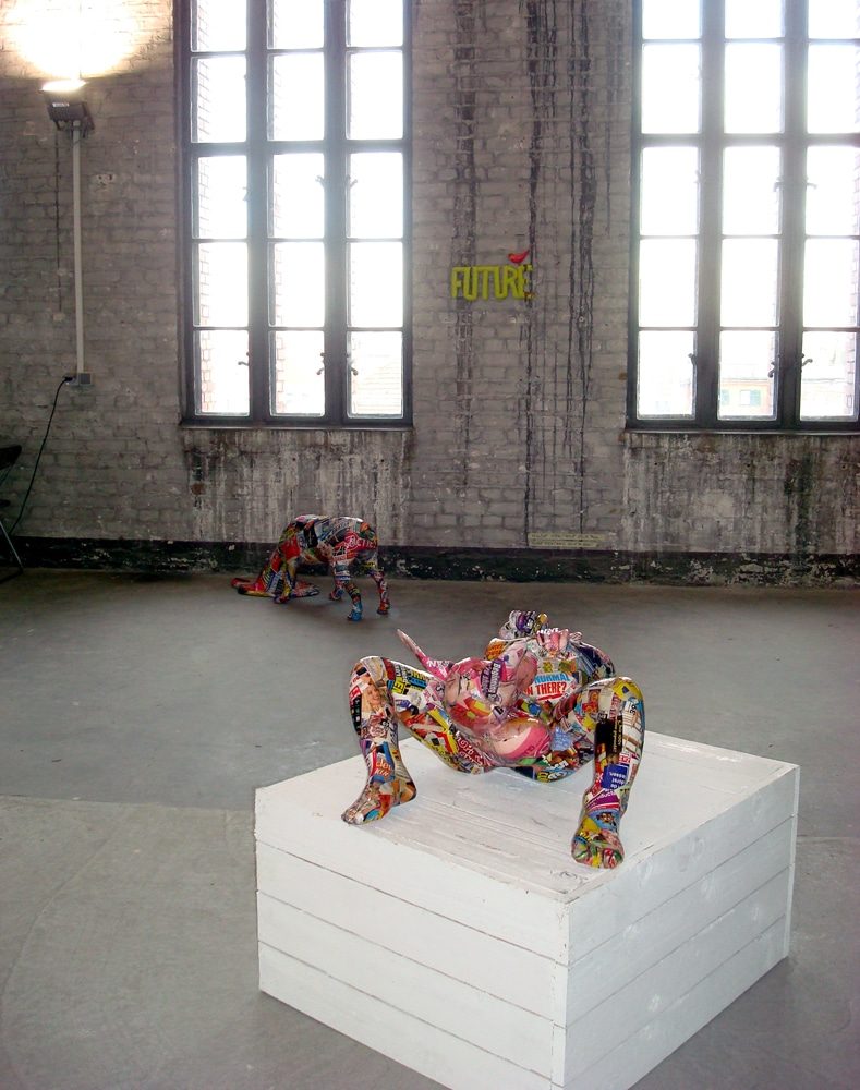 Sculptural figure giving birth to itself from its own body.