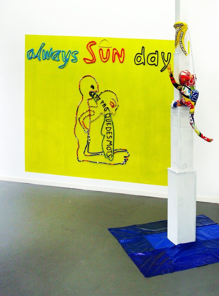 Installation view of ALWAYS SUN DAY with Welcome to Heavens Playground, a monkey made from plastic bags climbing toward an unreachable bunch of bananas.