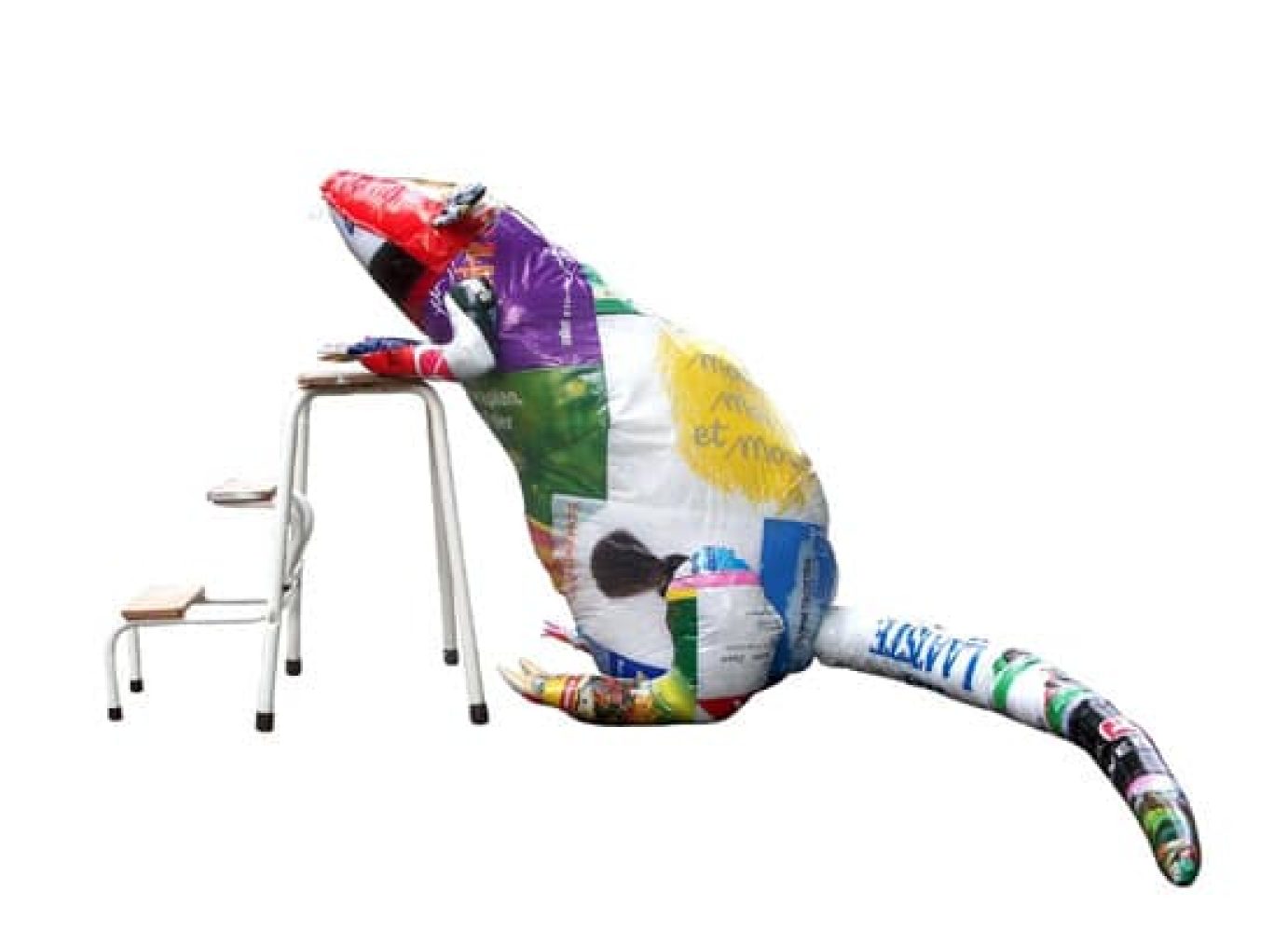 Large rat sculpture made from colourful plastic shopping bags leaning against a small stepladder.